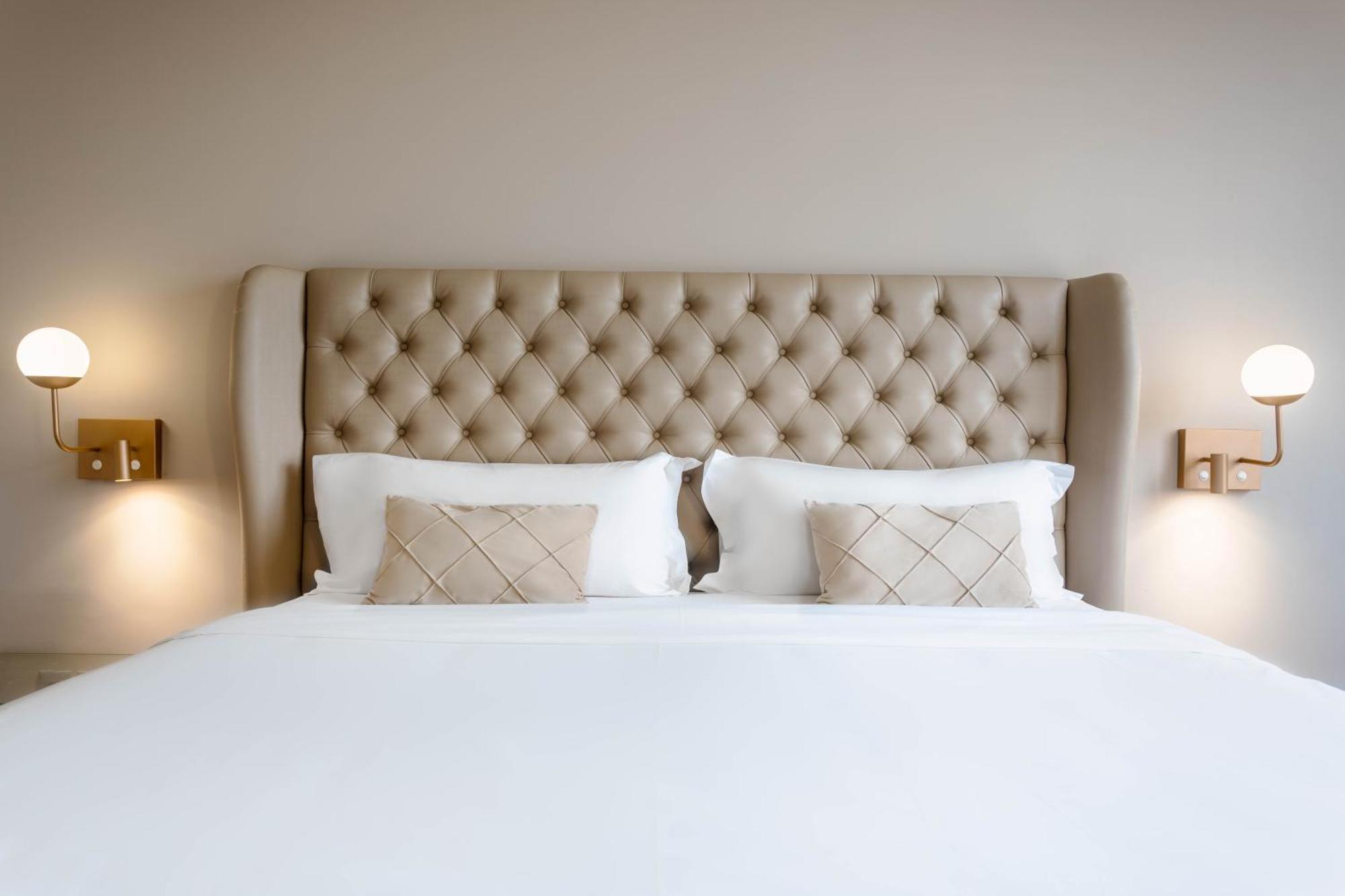 Ouro Minas Hotel Belo Horizonte, Dolce By Wyndham Eksteriør bilde A bed with a tufted headboard